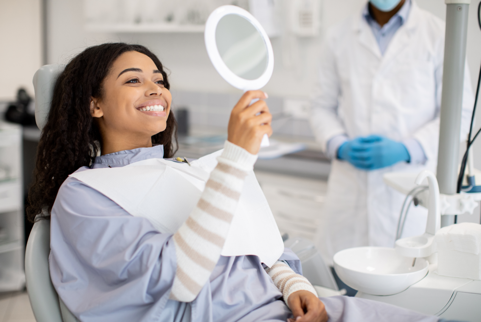 Woman smiling with dental mirror
