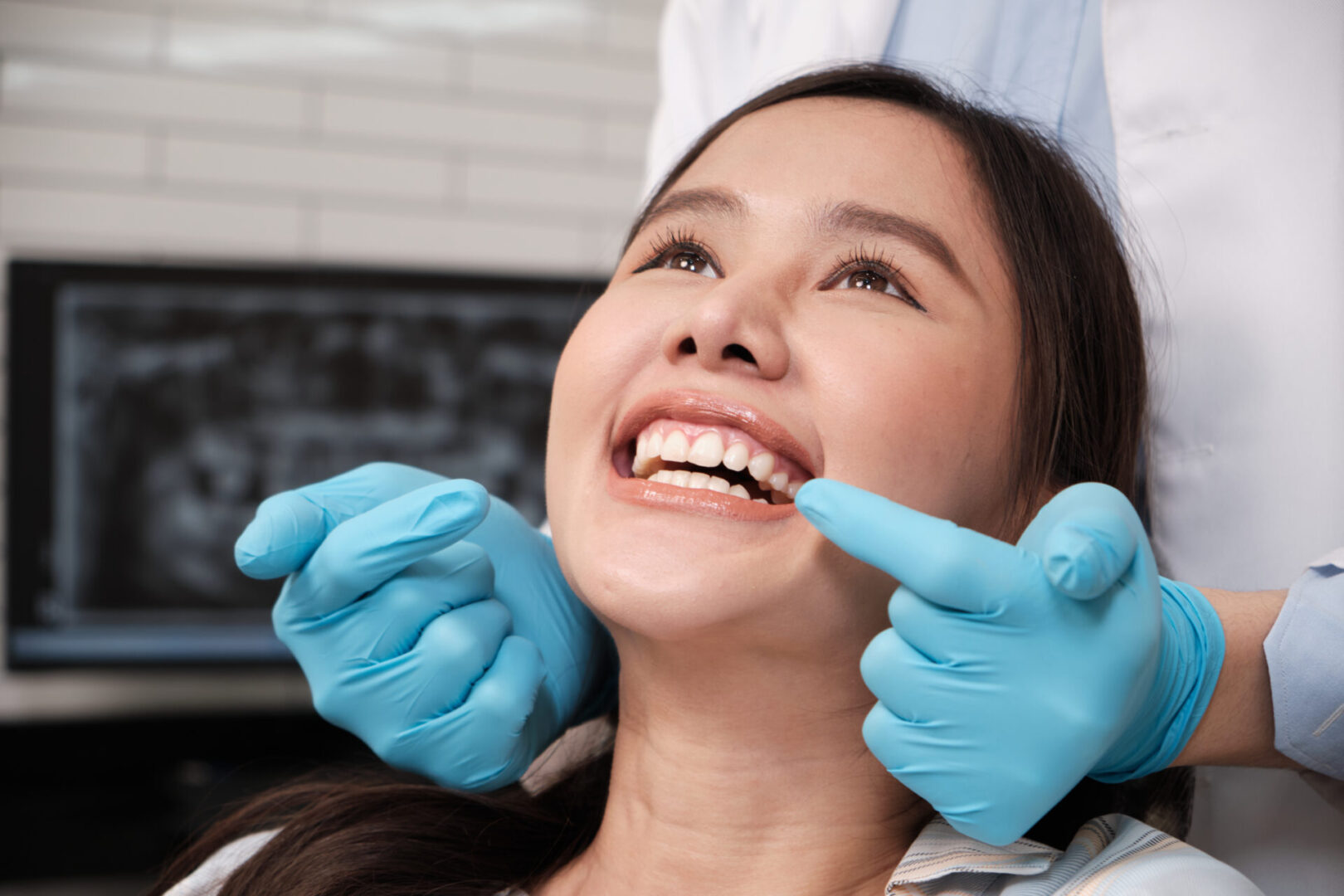 Dental professional wearing blue gloves
