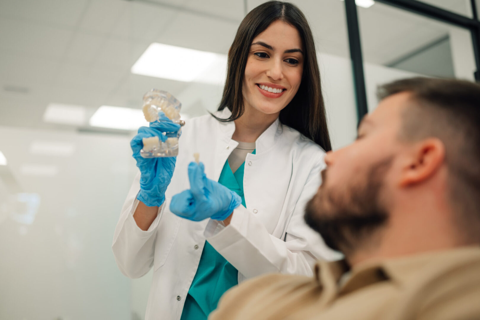 Dentist showing model to patient