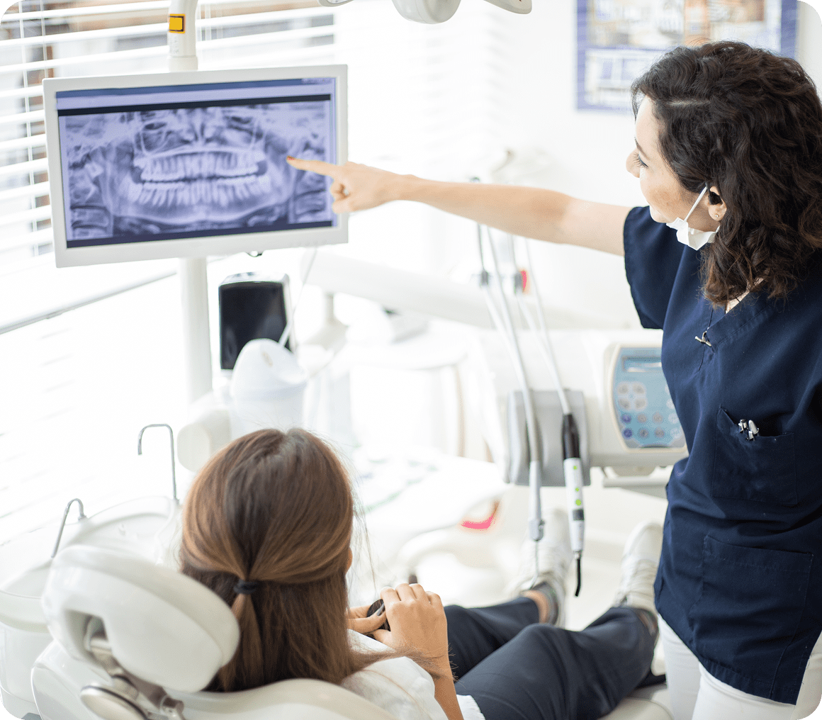 Dental professional showing X-ray results